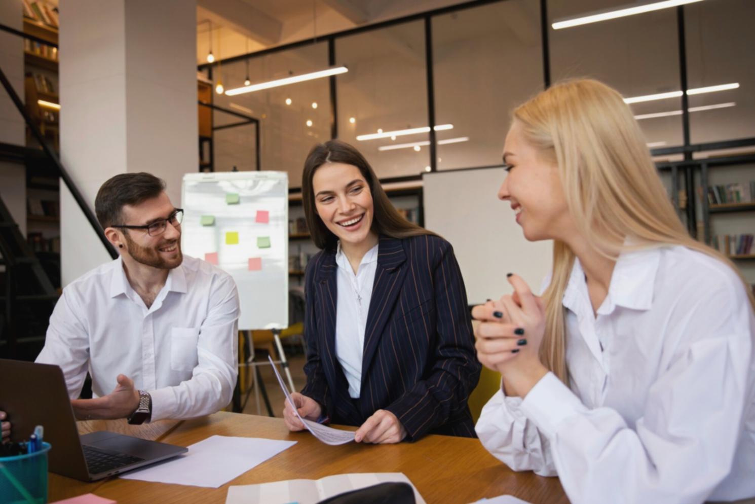 Students analyzing financial data on multiple monitors showing Thai stock market charts and comparative company metrics